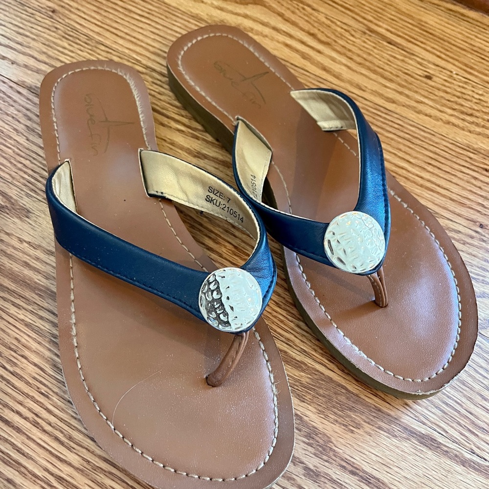 Report Navy and gold flip flops